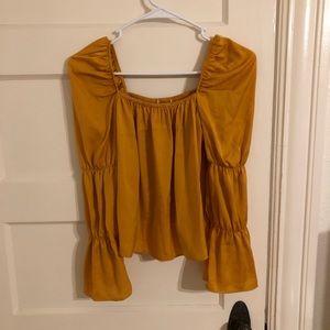 Mustard yellow silky top.